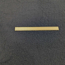 Load image into Gallery viewer, Flat lay of Cyndi Black textured stretch cotton, for sale at Minerva's Bower, with ruler for scale