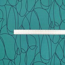 Load image into Gallery viewer, Klee is a stunning pure cotton with continuous, large scale, line drawings. Black on an emerald green background, available at Minerva's Bower. Image includes a ruler for scale