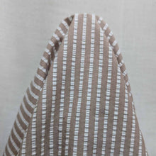 Load image into Gallery viewer, Flat lay of Joy cotton seersucker in fawn colourway. Available at Minerva's Bower. Fabric draped to show how it handles