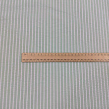 Load image into Gallery viewer, Flat lay of Joy cotton seersucker in mint colourway. Available at Minerva's Bower. Ruler included to show scale