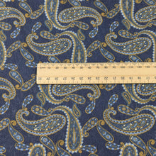 Load image into Gallery viewer, Close up of Patterned lyocell fabric with paisley design and a blue base, with a ruler for scale, for sale at Minerva's Bower