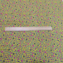 Load image into Gallery viewer, 100% cotton Floral patterned fabric with pink and purple flowers on a chartreuse background with ruler included for scale