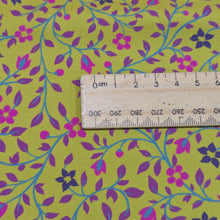 Load image into Gallery viewer, Close up of 100% cotton Floral patterned fabric with pink and purple flowers on a chartreuse background with ruler included for scale