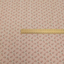 Load image into Gallery viewer, Japanese cotton fabric with a small floral pattern on a soft pink base, with ruler included for scale, for sale at Minerva's Bower