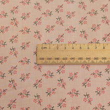Load image into Gallery viewer, Close up of Japanese cotton fabric with a small floral pattern on a soft pink base, with ruler included for scale, for sale at Minerva's Bower