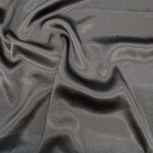 Load image into Gallery viewer, Flat lay of Prom viscose fabric in black. Available at Minerva's Bower. Fabric draped to show how it handles