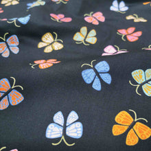 Load image into Gallery viewer, Flat lay of Ruby Star Society Ooh Lucky Lucky in Black. Available at Minerva's Bower. Fabric draped to show how it handles