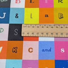 Load image into Gallery viewer, Close up of Ruby Star Cotton, Selvedge Magic, ruler included for scale, for sale at Minerva's Bower