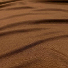 Load image into Gallery viewer, Flat lay of Stellar rayon rib in nutmeg colourway. Available at Minerva's Bower. Fabric draped to show how it handles