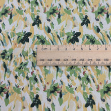 Load image into Gallery viewer, Close up of Japanese cotton fabric with a floral pattern with small flowers in greens and yellows,  with ruler included for scale, for sale at Minerva's Bower