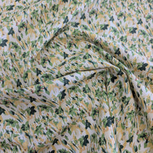 Load image into Gallery viewer, Drape of Japanese cotton fabric with a floral pattern with small flowers in greens and yellows, for sale at Minerva's Bower