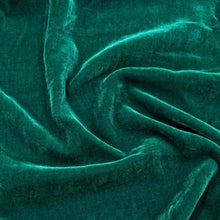 Load image into Gallery viewer, Flat lay of pure silk velvet in emerald colourway. Available at Minerva's Bower. Fabric draped to show how it handles