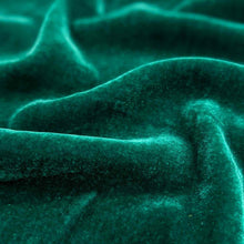 Load image into Gallery viewer, Flat lay of pure silk velvet in emerald colourway. Available at Minerva's Bower. Fabric draped to show how it handles