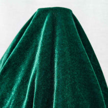 Load image into Gallery viewer, Flat lay of pure silk velvet in emerald colourway. Available at Minerva's Bower. Fabric draped to show how it handles