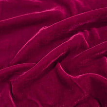 Load image into Gallery viewer, Flat lay of pure silk velvet in garnet colourway. Available at Minerva's Bower. Fabric draped to show how it handles