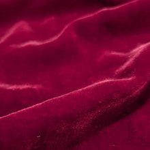Load image into Gallery viewer, Flat lay of pure silk velvet in garnet colourway. Available at Minerva's Bower. Fabric draped to show how it handles