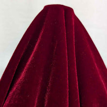 Load image into Gallery viewer, Flat lay of pure silk velvet in garnet colourway. Available at Minerva's Bower. Fabric draped to show how it handles