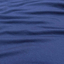 Load image into Gallery viewer, Flat lay of Stellar rayon rib, in indigo colourway. Available at Minerva's Bower. Fabric draped to show how it handles