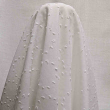Load image into Gallery viewer, Flat lay of white Zola swiss dot embroidered pure cotton. Available at Minerva's Bower. Fabric draped to show how it handles