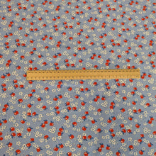 Load image into Gallery viewer, Flat lay of fabric with red apples and white flowers on a blue background in a vintage style, for sale at Minerva&#39;s Bower with a ruler included for scale