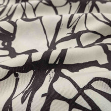 Load image into Gallery viewer, Close-up of fabric with black abstract pattern on white background. Fabric draped to show how it handles. Available at Minerva's Bower