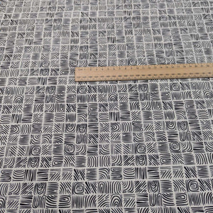 Art Gallery 100% cotton Fabric with a black geometric woodblock pattern on a cream background, measured by a ruler, for sale at Minerva's Bower