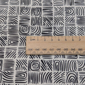 Woodblock patterned 100% cotton     fabric with a ruler for scale on a cream background, for sale at Minerva's Bower
