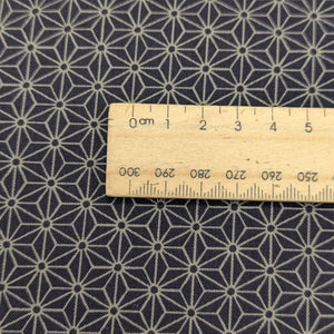Close up of Dark navy Japanese 100% cotton fabric with traditional Hemp leaf design, for sale at Minervas Bower and a ruler included for scale 