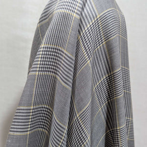 Draped Yarn dyed Plaid fabric with black, white, and yellow pattern for sale at Minerva's Bower
