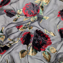 Load image into Gallery viewer, Floral pattern with red and black flowers on a dark background. Devore silk velvet, available at Mierva's Bower. Fabric draped to show how it handles