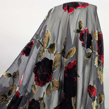 Load image into Gallery viewer, Floral pattern with red and black flowers on a dark background. Devore silk velvet, available at Minerva's Bower. Fabric draped to show how it handles