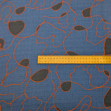 Load image into Gallery viewer, Abstract pattern with orange and black lines on a blue background of cotton dobby fabric. Available at Minerva's Bower. Ruler included for scale