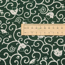 Load image into Gallery viewer, Pattern of white cats and swirls on a green cotton dobby background. Made in Japan. Available at Minerva's Bower. Ruler included for scale