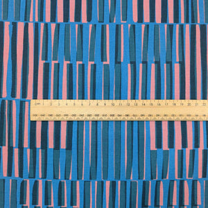 Ruby Star Society Fabric with blue and pink striped pattern and a ruler for scale. Available at Minerva's Bower