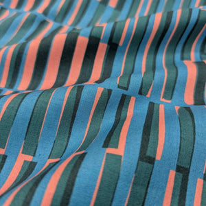 Close-up of Ruby Star Society fabric with blue, green, and red striped pattern. Available at Minerva's Bower
