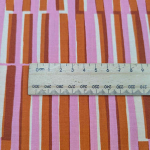 Ruby Star Society Fabric with pink and orange striped pattern and a ruler for scale. Available at Minerva's Bower