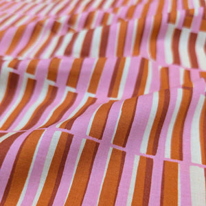 Close-up of Ruby Star Society fabric with pink, orange, and white striped pattern. Available at Minerva's Bower