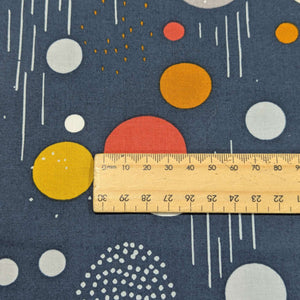 100% cotton Fabric with colorful geometric patterns on a blue background and a ruler for scale, for sale at MInerva's Bower