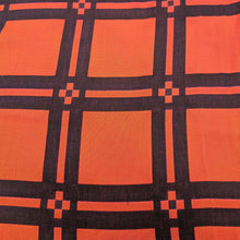 Load image into Gallery viewer, Flat lay of triple gauze Fabric with a checkered pattern of pink, orange, and black on a black background. Available at Minerva&#39;s Bower