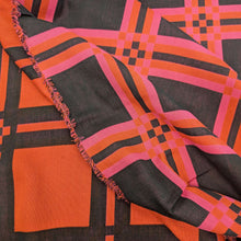 Load image into Gallery viewer, Flat lay of triple gauze Fabric with a checkered pattern of pink, orange, and black on a black background. Available at Minerva&#39;s Bower. Ruler included for scale