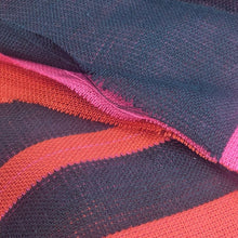 Load image into Gallery viewer, Flat lay of triple gauze Fabric with a checkered pattern of pink, orange, and black on a black background. Available at Minerva&#39;s Bower. Ruler included for scale