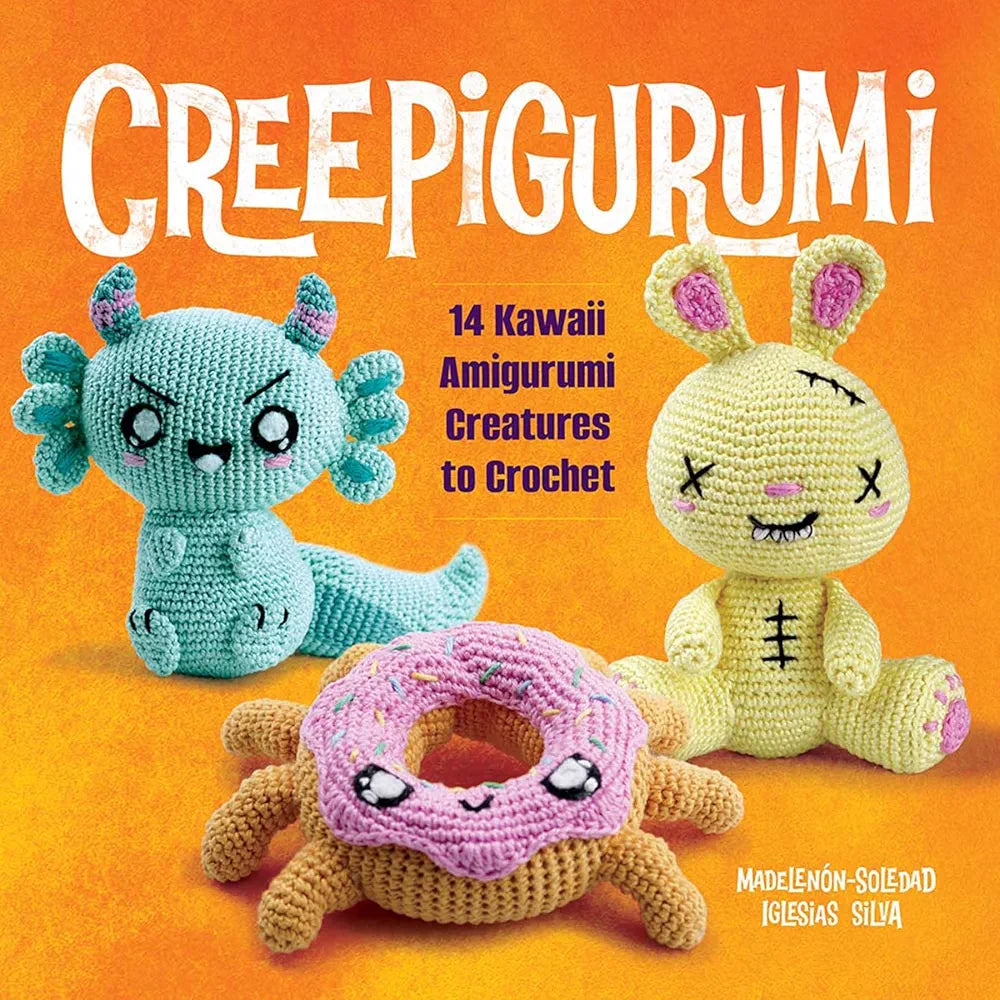 Book cover of 'Creepigurumi' with three colorful amigurumi creatures on an orange background, available at Minerva's Bower
