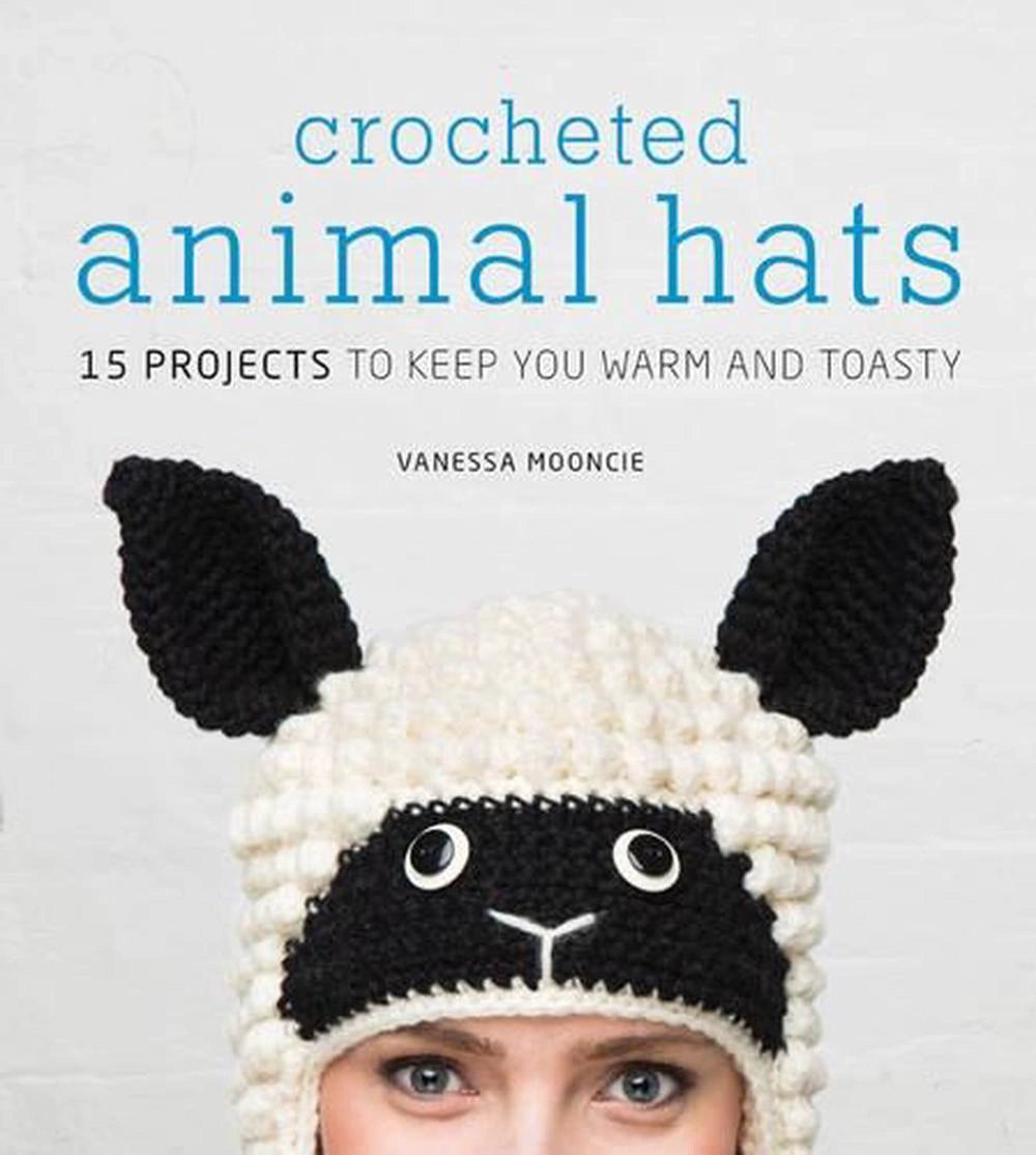 Book cover of 'Crocheted Animal Hats' by Vanessa Moondie with a person wearing a cat-themed crochet hat, available at Minerva's Bower