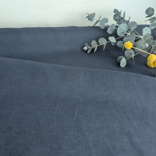 Load image into Gallery viewer, Flat lay of 100% European Delave Linen, Navy  with flowers and foliage - for sale at Minerva's Bower