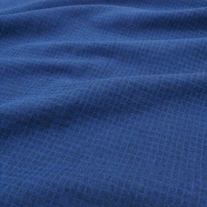 Flat lay of cotton linen dobby check in indigo. Available at Minerva's Bower. Fabric draped to show how it handles