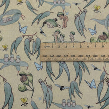 Load image into Gallery viewer, Close up flat lay of 70% Bamboo 30% cotton Double Gauze, May Gibbs Garden Playtime - Yellow, with ruler included for scale, for sale at Minerva's Bower