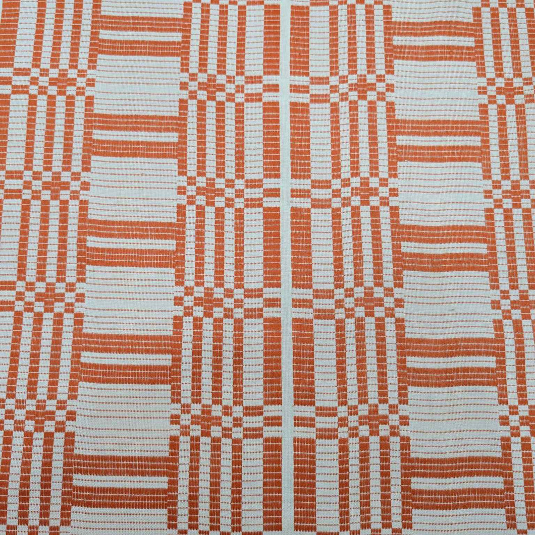 Flat lay of pure Indian cotton jacquard, Fableism Astrid Weave, in orange colourway. Available from Minerva's Bower