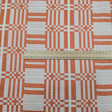 Load image into Gallery viewer, Flat lay of pure Indian cotton jacquard, Fableism Astrid Weave, in orange colourway. Available from Minerva&#39;s Bower. Ruler included for scale