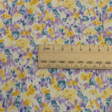 Load image into Gallery viewer, Close up of Japanese cotton fabric with a floral pattern with small flowers in purple, yellow and blue, with ruler included for scale, for sale at Minerva&#39;s Bower