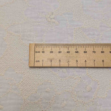 Load image into Gallery viewer, Close up flat lay of Fiore, 100% Embroidered Ivory cotton double gauze, ruler included for scale, for sale at Minerva's Bower